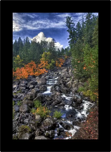 A fall scene of flowing water along the Empqua River in Steamboat Oregon