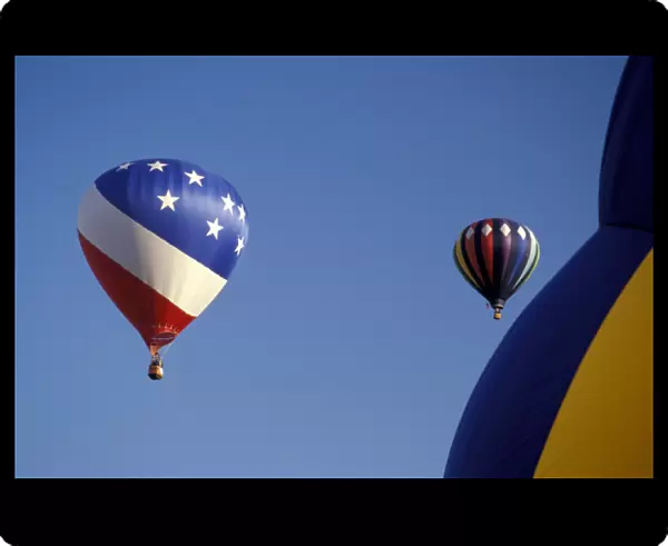 NA, USA, WA, Walla Walla, two balloons fly in a clear blue sky and third in foreground