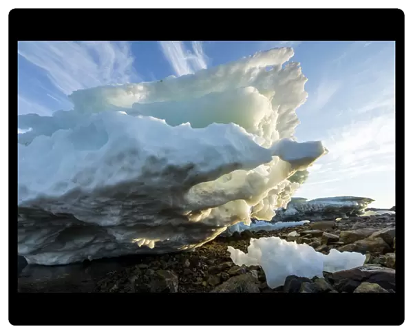 Canada, Nunavut Territory, Melting iceberg stranded by low tide along Frozen Channel