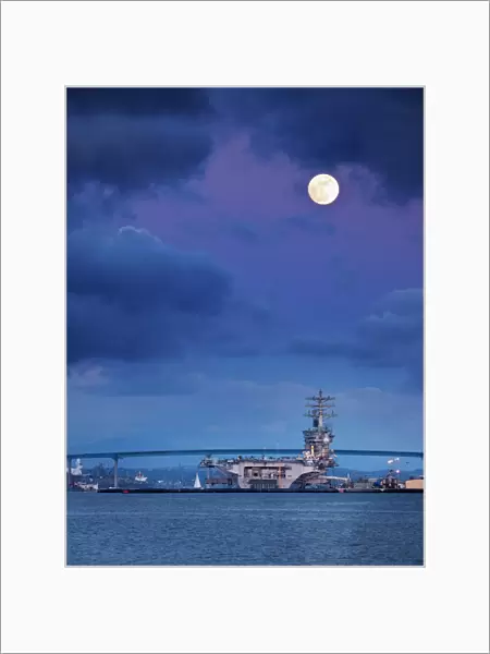 USA, California, San Diego, USS Nimitz moored under full moon in San Diego Bay