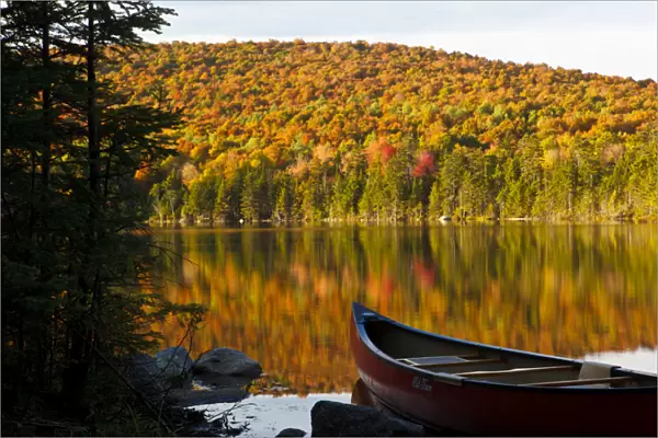 A canoe on the shoreline of Pond of Safety in the Randolph Community Forest