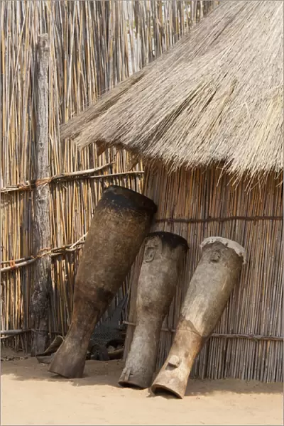 Africa, Namibia, Caprivi Strip. Tribal drums lean on grass hut in Mbukushu Tribe village