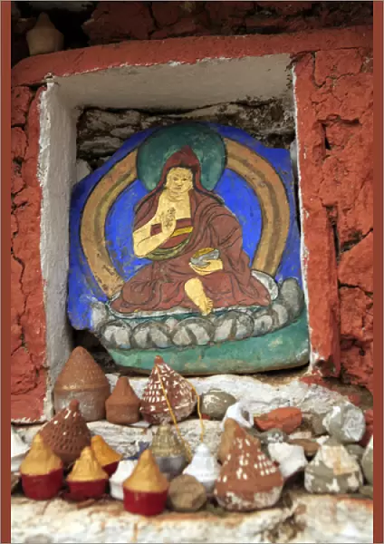 Asia, Bhutan, Paro. Miniature clay stupas rest on ledge of Taktsang trailside altar
