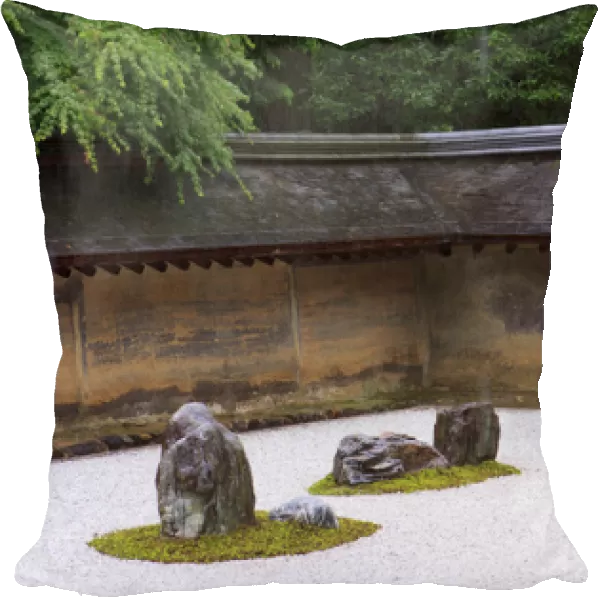 The carefully placed rocks and raked gravel gardens of the Zen garden of Ryoan-Ji Temple in Kyoto