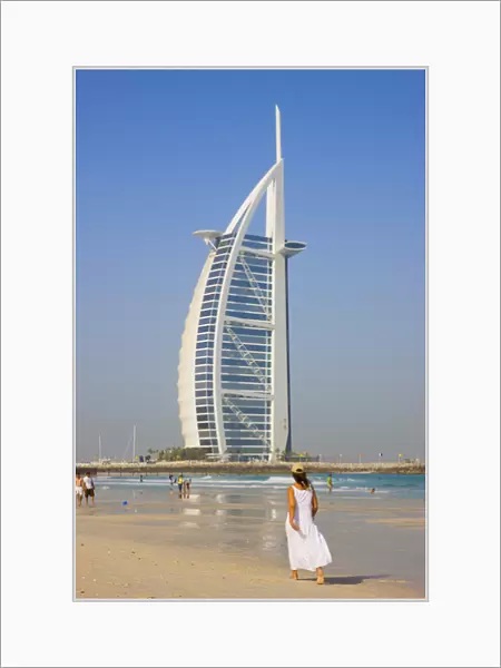 Tourists on the beach with Burj Al Arab Hotel in the distance, Dubai, UAE