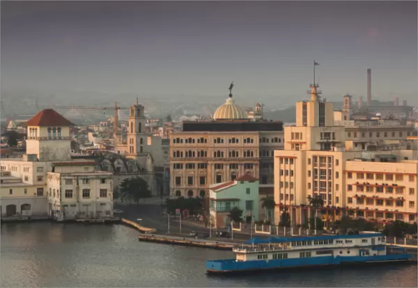 Cuba, Havana, Havana Vieja, elevated view of buildings along Havana Bay, dawn
