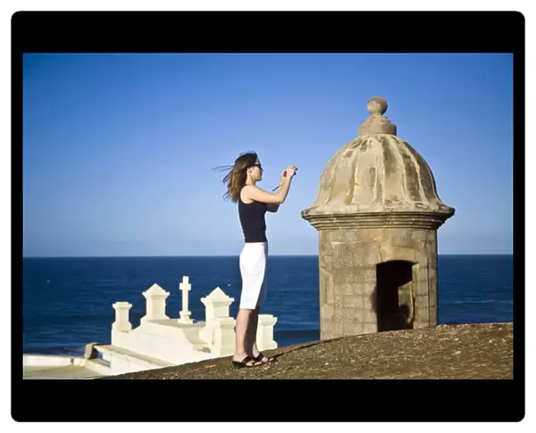 El Morro fortress and Church. Old San Juan. Puerto Rico. Woman taking a photo