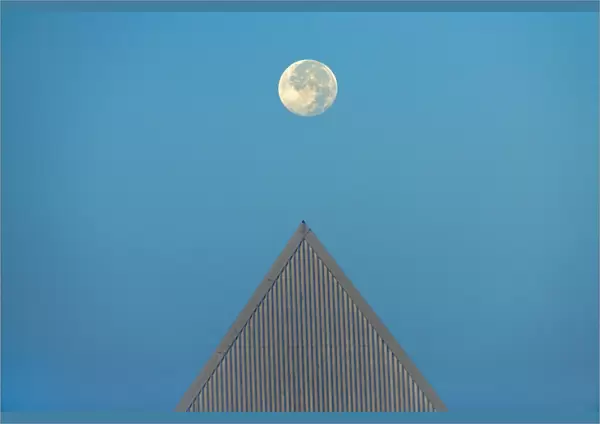 Canada, Ontario, St. Catharines. Full moon and triangular-shaped roof at Brock University