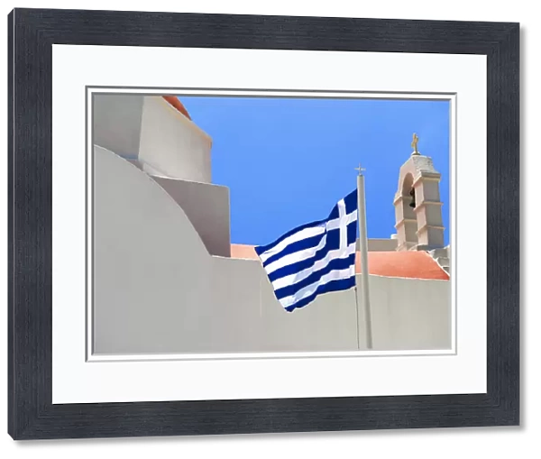 Greece; Mykonos; Chora. The Greek flag flys over the Island of Mykonos