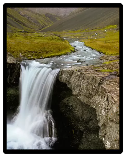 Water running from Glacier and waterfall, Iceland