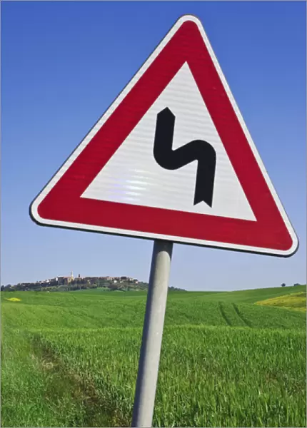 Europe, Italy, Tuscany, Pienza. Road sign warns of sharp road turns outside town