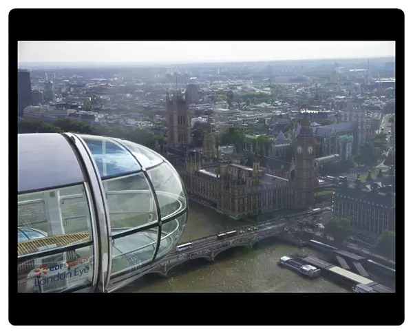 A close up shot of the glass capsule on the London Eye as it passes Parliment and Big Ben