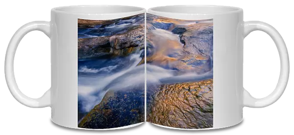 USA, Arizona, Sedona. Reflections on water flowing over rock