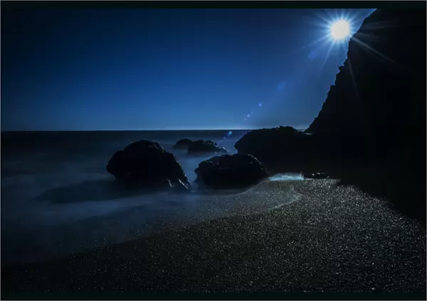 Long exposure of sun on beach and rocks on northern California coastline