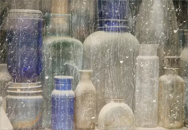 USA, Idaho, Idaho City. Close-up of dusty bottles in window