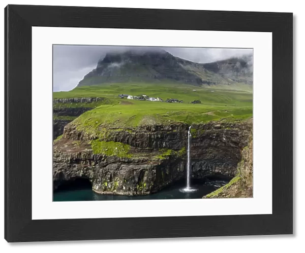 The waterfall near Gasadalur, one of the landmarks of Faroe Islands. The island Vagar