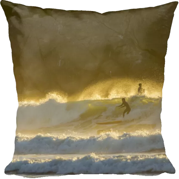 USA, California, San Luis Obispo County. Surfers at sunset