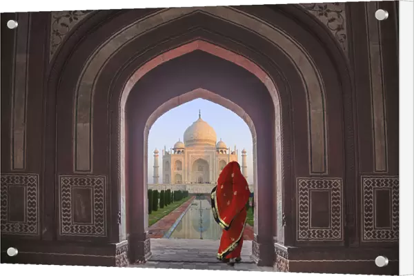 India, Agra, Taj Mahal. Composite of woman in archway facing mausoleum