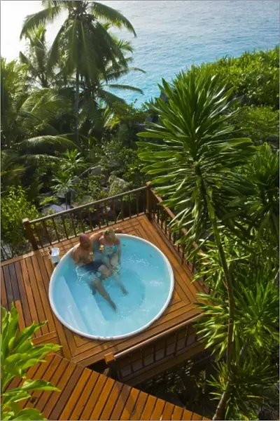 Couple enjoying hot tub at Fregate Resort (MR) (PR)