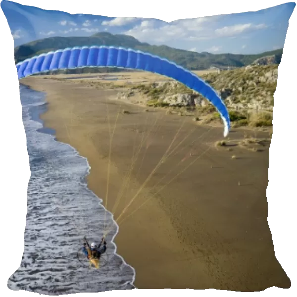 Powered paraglider flying over beach in Dalyan, aerial view, Koycegiz, Mugla, Turkey