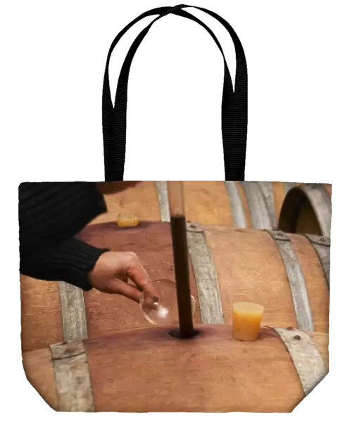 Philippe Viret taking a barrel sample of aging red wine. Domaine Viret, Saint Maurice sur Eygues