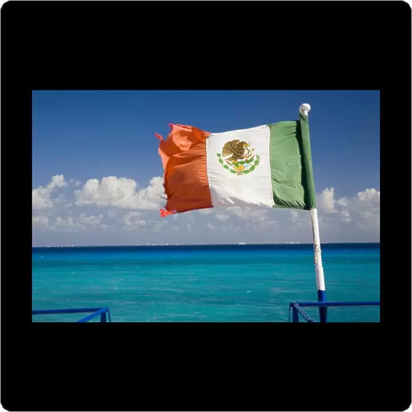 North America, Mexico, Quintana Roo, Cozumel. The Mexican flag flying off the stern