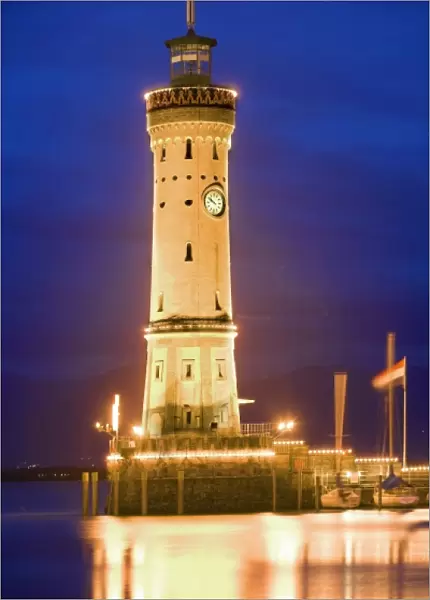 Germany, Lake Constance. View of lighthouse on Lindau Island at sunset
