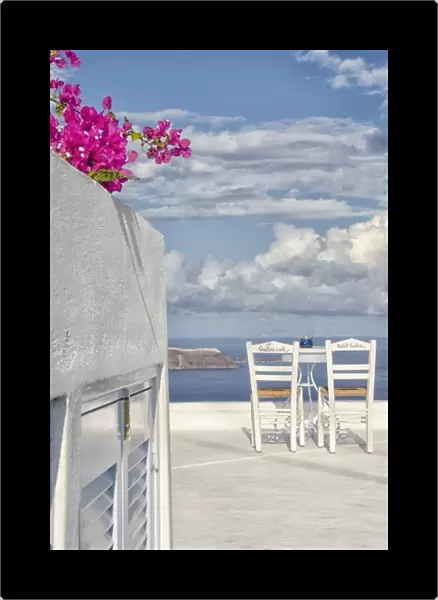 Two lonely romantic chairs on balcony with sky in Fira in Santorini Greece in Greek