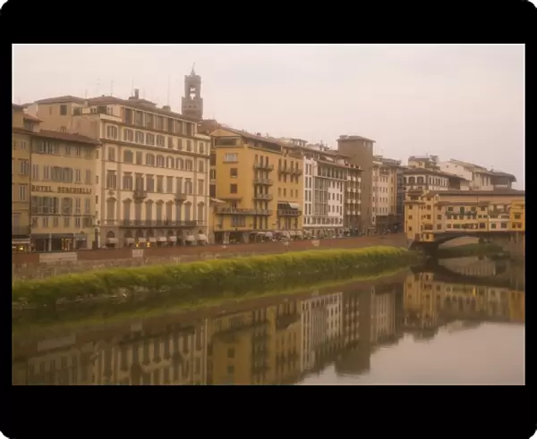 Italy, Florence. Buildings reflect in the Arno River