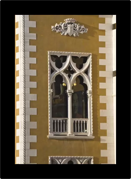 Italy, Venice. Window of Palazzo Cavalli-Franchetti with image of chairman inside
