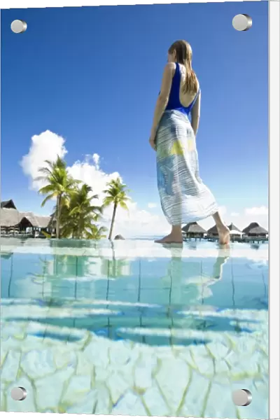 South Pacific, Bora Bora, female tourist relaxing at resort. (MR)