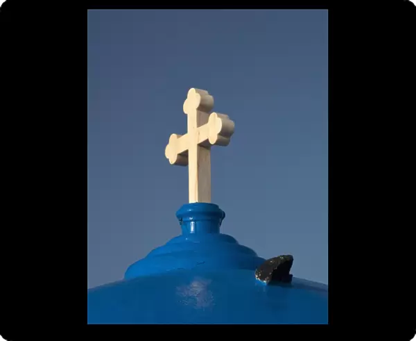Greece, Santorini. Church with blue dome and white cross in village of Firostefani