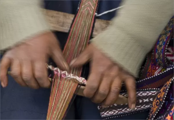 Hands weaving on traditional foot loom, Cuzco, Peru