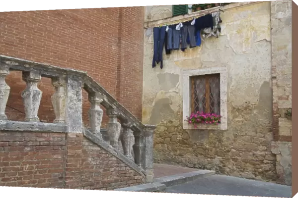 Italy, Asciano, Window Boxes with Fresh Spring Flowers and Laundry Hanging on The Line