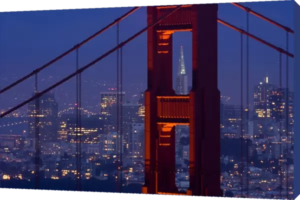 A dusk view of San Francisco with the Transamerica building through the Golden Gate Bridge