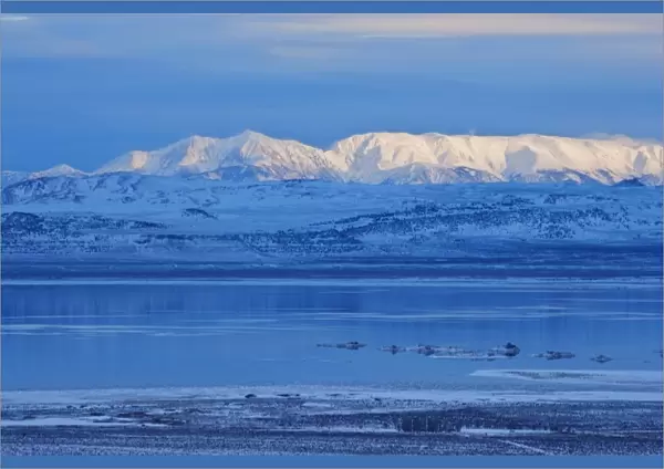 USA, California, Mono Lake. Snow-covered mountains and the lake in winter