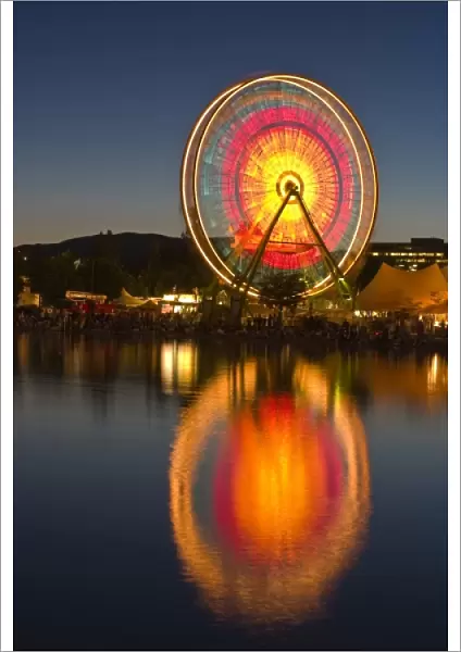 USA, California, Marin County. Spinning ferris wheel reflects in lake at Civic Center Fairgrounds
