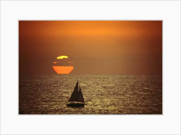 A sailboat at sunset in California