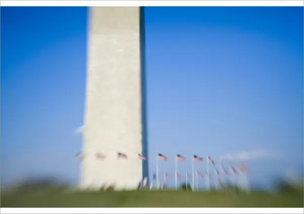 American flags surround Washington Monument (blurred), Washington D. C. (District of Columbia)
