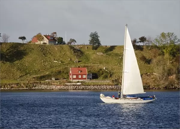 Sweden, Skane, Isle of Ven. Sailboat passing Isle of Ven. Sailing is a common activity in Oresund
