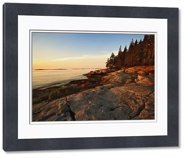 Granite shoreline of Rockport Harbor at sunrise, Rockport, Maine