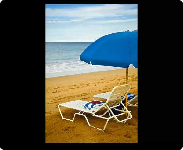 USA, Hawaii, Maui. Beach umbrellas and chairs wait for vacationers