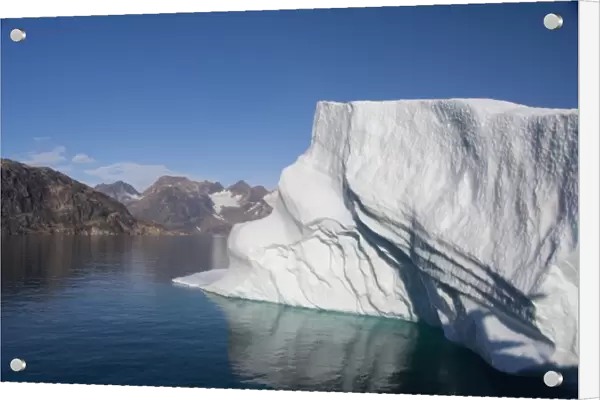 Greenland, Southeast coast, Skjoldungen Fjord. Large iceberg in scenic fjord surrounded