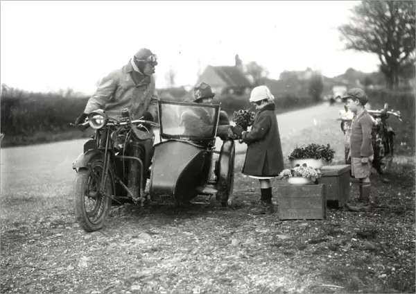 Children selling wild flowers to motorists, April 1927