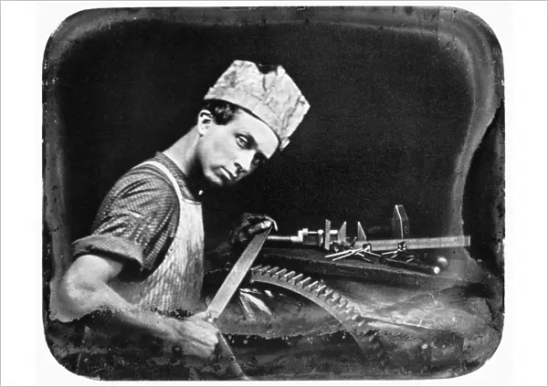 A machinists apprentice with file and gear. Daguerreotype, American, c1850