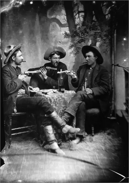 CARD PLAYERS, c1870. Three gunslingers in the American West playing cards. Tintype