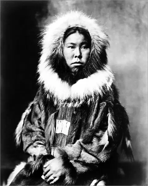 ESKIMO WOMAN, c1903. Inuit woman seated and wearing traditional fur clothing. Photograph
