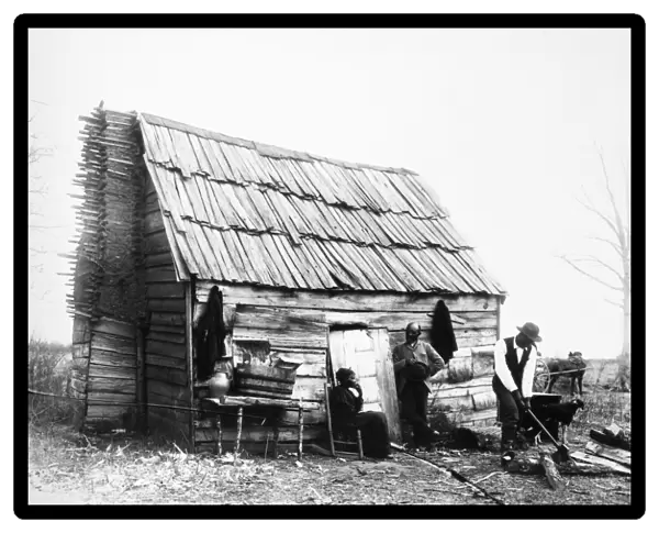 SHARECROPPERS, 1899. An African American family outside their house in Virginia