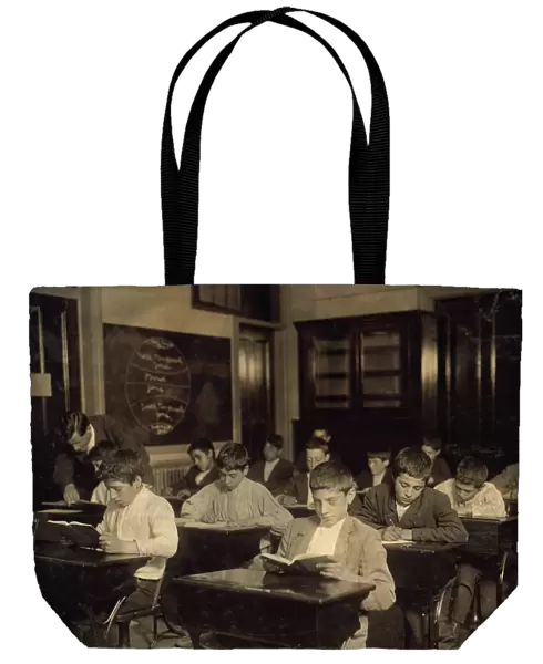NIGHT SCHOOL, 1909. Working immigrant boys in a evening class for all nationalites in Boston