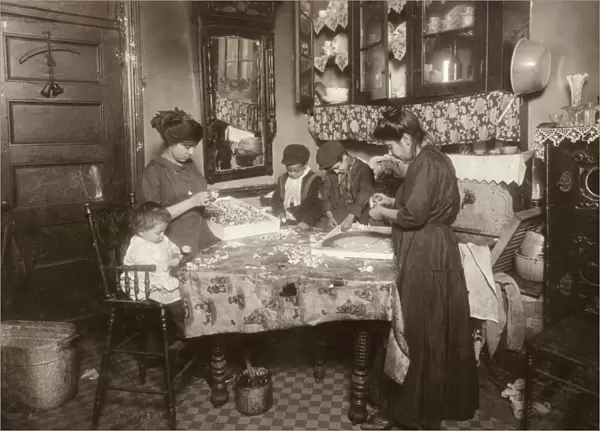 HINE: HOME INDUSTRY, 1911. A family making flowers in a unsanitary tenement apartment